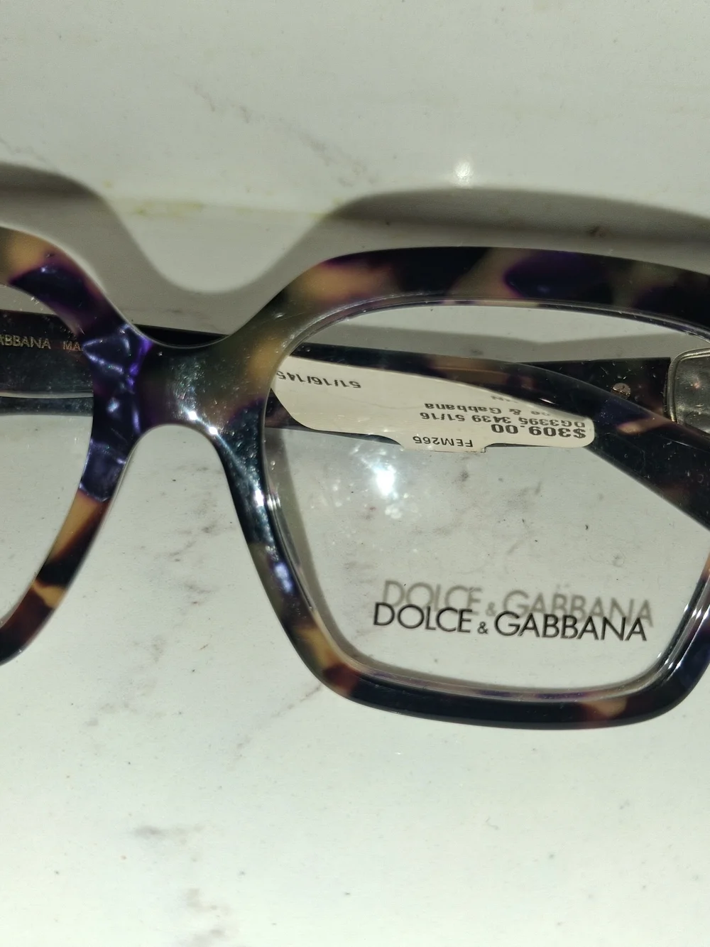 Dolce & Gabbana DG3395 eyeglasses feature a striking Havana Blue Pearl tortoises